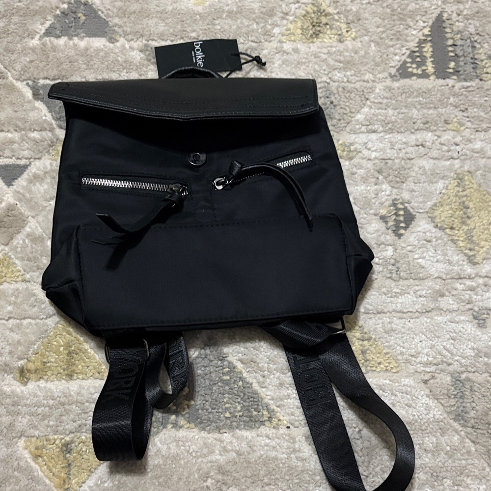 DKNY Sleek Black Backpack with Silver Accents